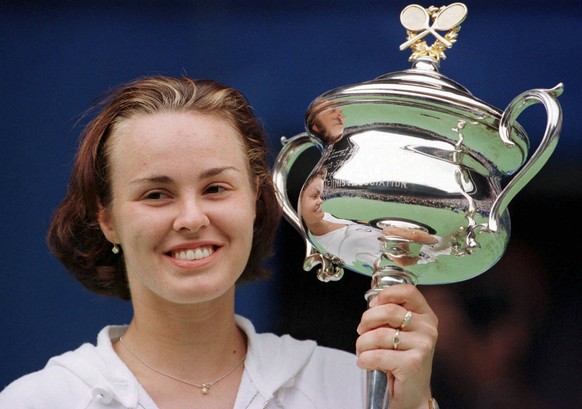 Martina Hingis of Switzerland holds her trophy after winning the women&#039;s final against Amelie Mauresmo of France at the Australian Open Tennis Championships in Melbourne, Australia, Saturday, Jan ...
