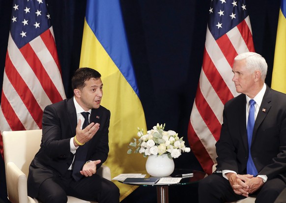 Ukraine&#039;s President Volodymyr Zelenskiy, left, gestures next to U.S. Vice President Mike Pence, during a bilateral meeting in Warsaw, Poland, Sunday, Sept. 1, 2019. (AP Photo/Petr David Josek)