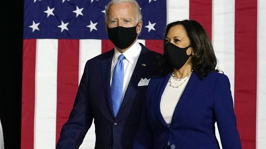 Democratic presidential candidate former Vice President Joe Biden and his running mate Sen. Kamala Harris, D-Calif., arrive to speak at a news conference at Alexis Dupont High School in Wilmington, De ...