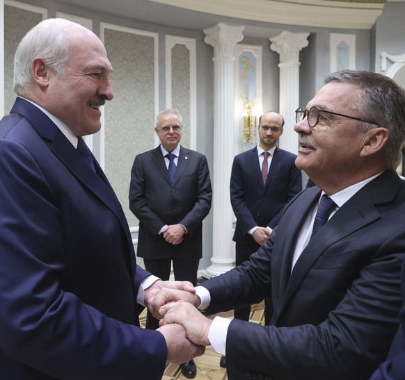 Belarusian President Alexander Lukashenko, left, greets International Ice Hockey Federation President Rene Fasel during their meeting in Minsk, Belarus, Monday, Jan. 11, 2021. (Nikolai Petrov/BelTA Po ...