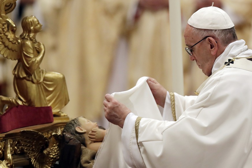 Pope Francis unveils a statue of Baby Jesus as he celebrates the Christmas Eve Mass in St. Peter&#039;s Basilica at the Vatican, Sunday, Dec. 24, 2017. (AP Photo/Alessandra Tarantino)