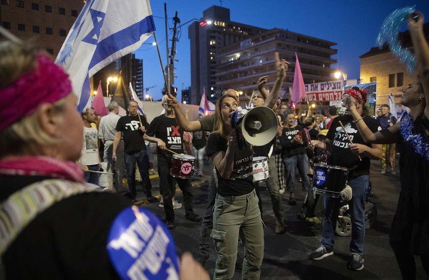 Israeli protesters dance and cheer during a demonstration against Israeli Prime Minister Benjamin Netanyahu outside his official residence in Jerusalem, Saturday, June 12, 2021. If all goes according  ...