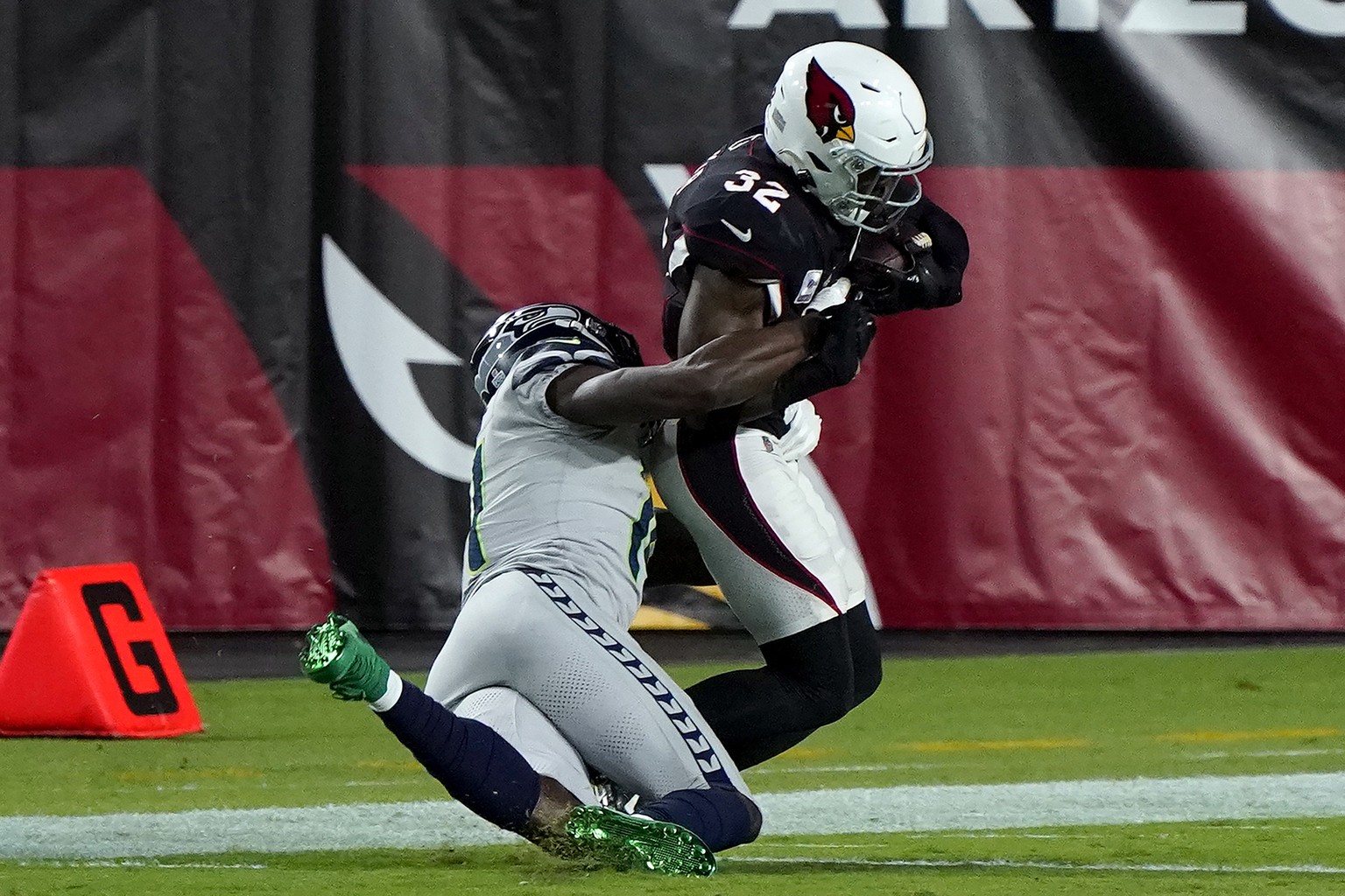 Seattle Seahawks wide receiver DK Metcalf tackles Arizona Cardinals strong safety Budda Baker (32) short of the goal line after Baker intercepted a pass during the first half of an NFL football game,  ...
