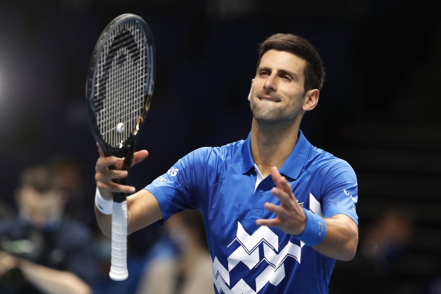 Novak Djokovic of Serbia celebrates winning match point against Alexander Zverev of Germany during their singles tennis match at the ATP World Finals tennis tournament at the O2 arena in London, Frida ...