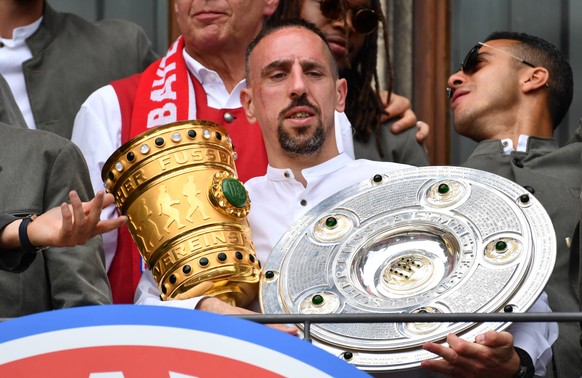 epa07602717 Bayern&#039;s Franck Ribery holds the German Bundesliga championship trophy (R) and the the DFB Cup trophy during the celebration of FC Bayern Munich winning German championship and DFB Cu ...