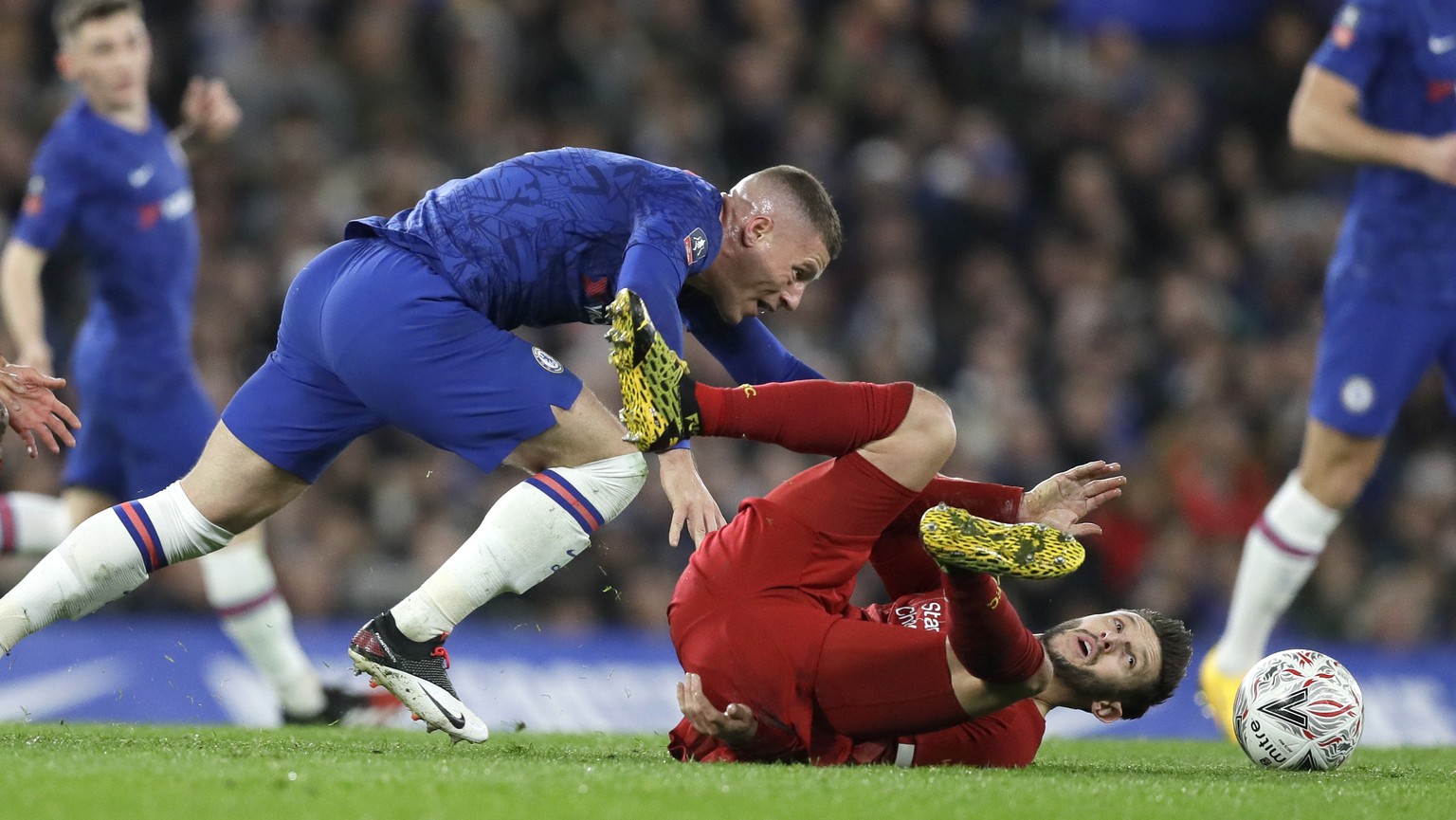 Liverpool&#039;s Adam Lallana falls as Chelsea&#039;s Ross Barkley, left, watches during the English FA Cup fifth round soccer match between Chelsea and Liverpool at Stamford Bridge stadium in London  ...