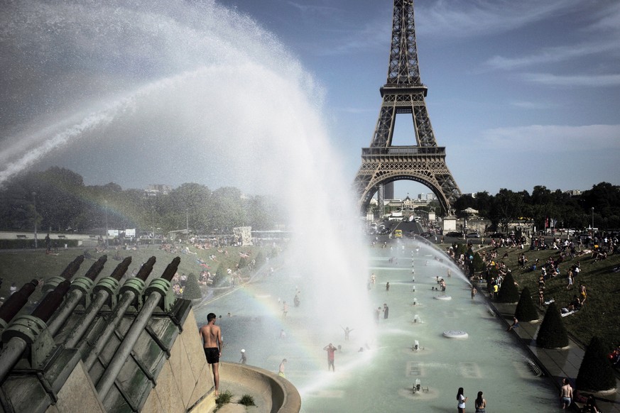 People cool off in the fountains of the Trocadero gardens, in front of the Eiffel Tower, in Paris, Friday, June 28, 2019. Schools are spraying kids with water and nursing homes are equipping the elder ...