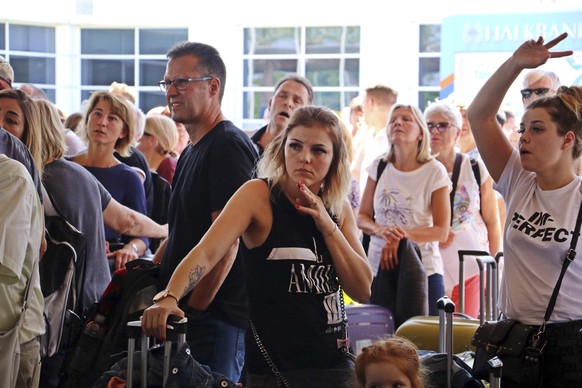 British passengers with Thomas Cook wait in queue at Antalya airport in Antalya, Turkey, Monday Sept. 23, 2019. Hundreds of thousands of travellers were stranded across the world Monday after British  ...