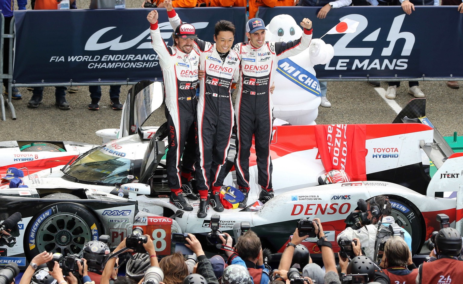 epa06815840 Fernando Alonso (L) of Spain , Kazuki Nakajima (C) of Japan and Sebastien Buemi (R) of Switzerland celebrate after winning the 24h Le Mans race with a Toyota Gazoo Racing (starting n.8) in ...
