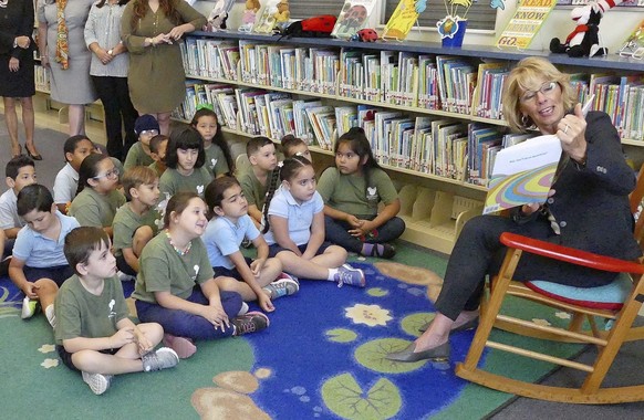 FILE - In this Tuesday, Feb. 14, 2017 file photo, Secretary of Education Betsy DeVos reads Dr. Seuss to kindergarten students at Royal Palm Elementary School in Miami. In her first major policy addres ...