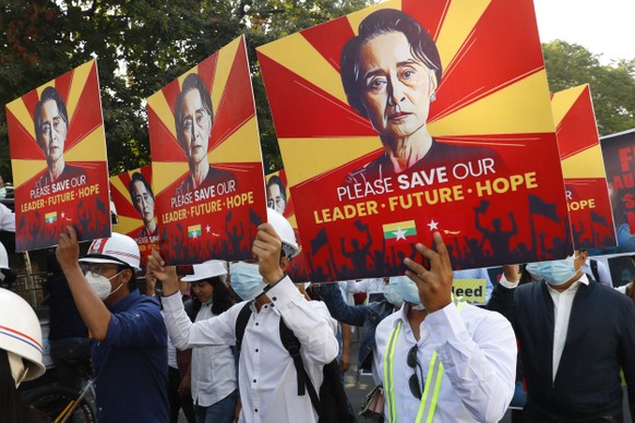 Engineers hold posters with an image of deposed Myanmar leader Aung San Suu Kyi as they stage an anti-coup protest march in Mandalay, Myanmar, Monday, Feb. 15, 2021. The hopes of building a robust dem ...