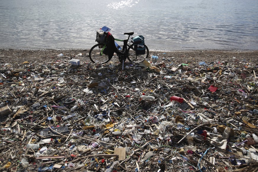 In this Wednesday, Jan. 17, 2018 photo a bicycle is parked next to plastics and other garbage on a beach in Neo Faliro, southern Athens. Greece has the European Union’s longest coastline, poor waste m ...