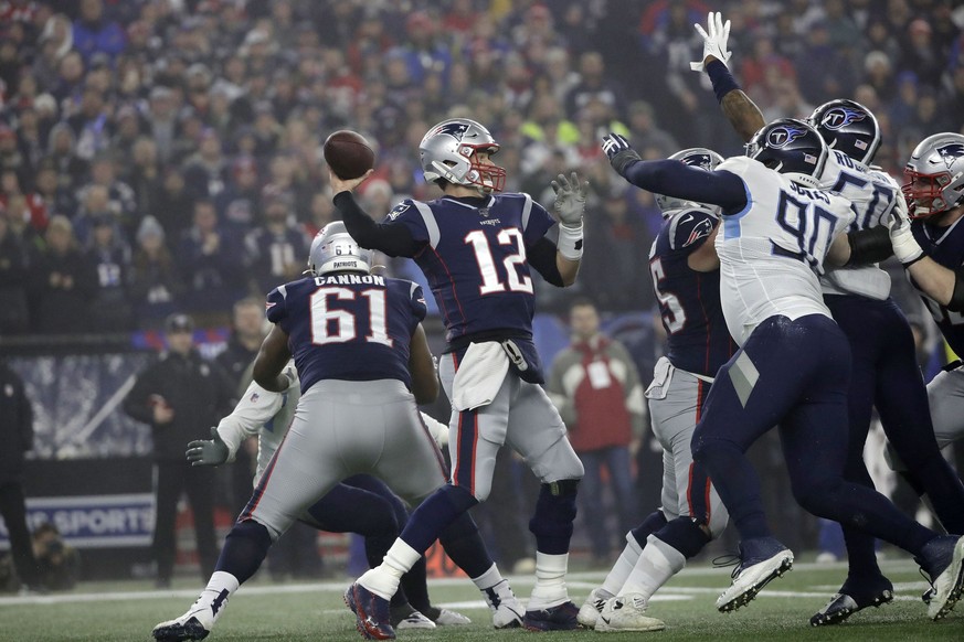 New England Patriots quarterback Tom Brady, center, passes under pressure from Tennessee Titans defensive end DaQuan Jones (90) and linebacker Derick Roberson (50) in the first half of an NFL wild-car ...