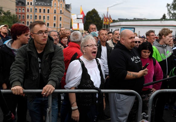 epa06984820 Demonstrators gather at the stadium of Chemnitz FC soccer club in Chemnitz, Germany, 30 August 2018. The Premier of Saxony invited citizens to a so called &#039;Saxony Talk&#039; dialogue  ...