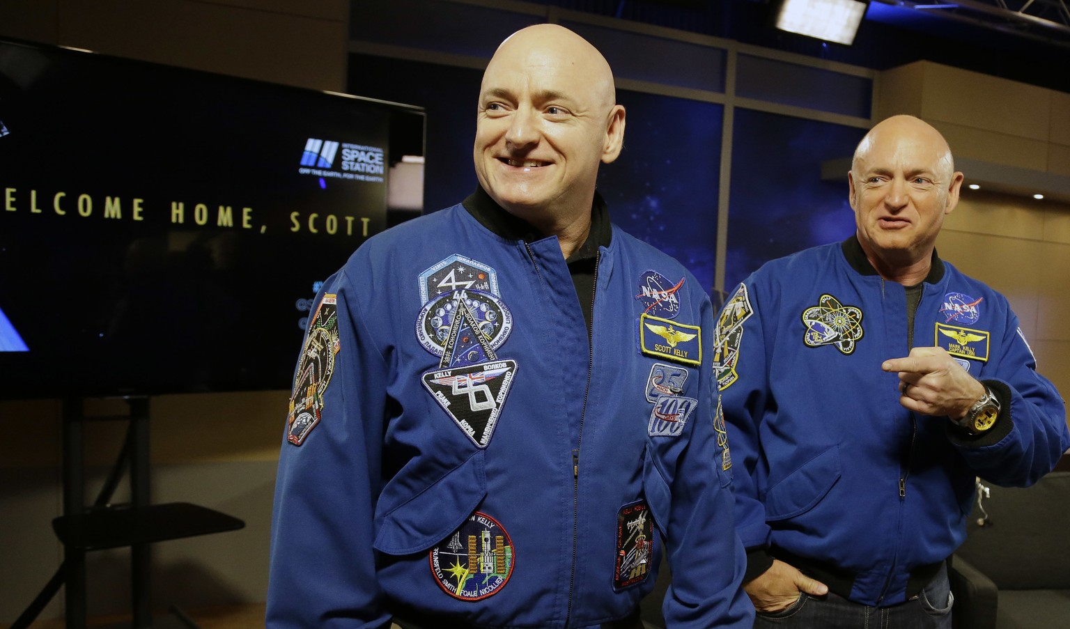 FILE - In this March 4, 2016, file photo, NASA astronaut Scott Kelly, left, and his twin Mark get together before a press conference in Houston. Scott Kelly set a U.S. record with his a 340-day missio ...