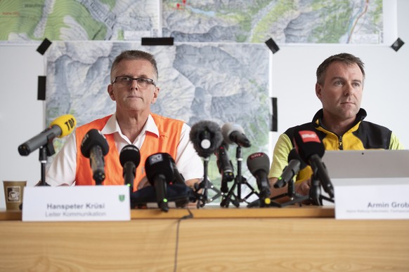 epa08600798 Hanspeter Kruesi (L), police spokesman, and Armin Grob (R), member of the search and rescue service of Alpine Rettung Ostschweiz, attend a press conference by police regarding a canyoning  ...