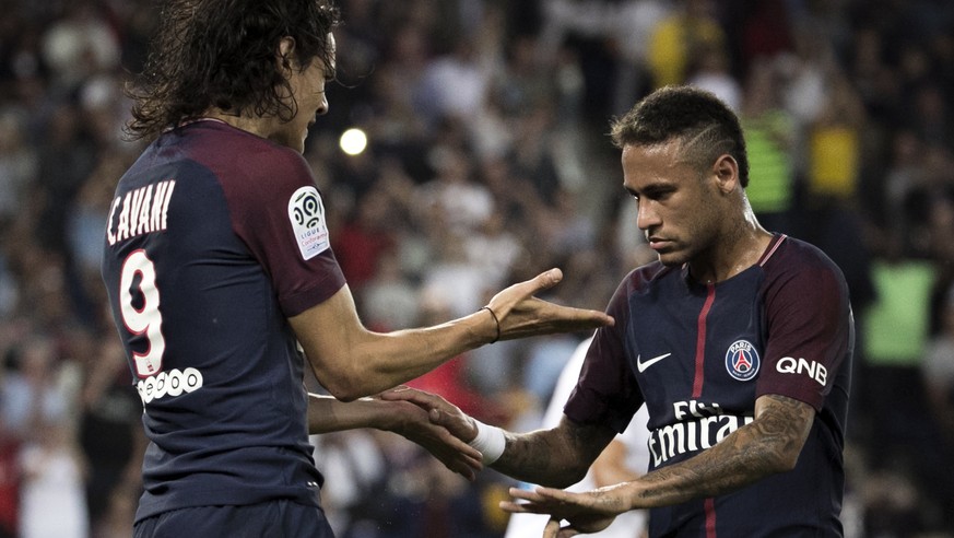 PSG&#039;s Edinson Cavani, left, reacts with teammate Neymar after a goal was scored, during the French League One soccer match between Paris Saint Germain and Saint Etienne at the Parc des Princes st ...