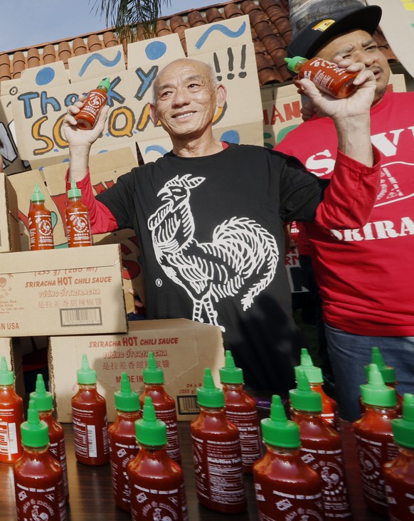 Sriracha hot sauce founder David Tran, second from right, with his workers and supporters protest ahead of the city council meeting in Irwindale, Calif., Wednesday, April 23, 2014. The Irwindale City  ...
