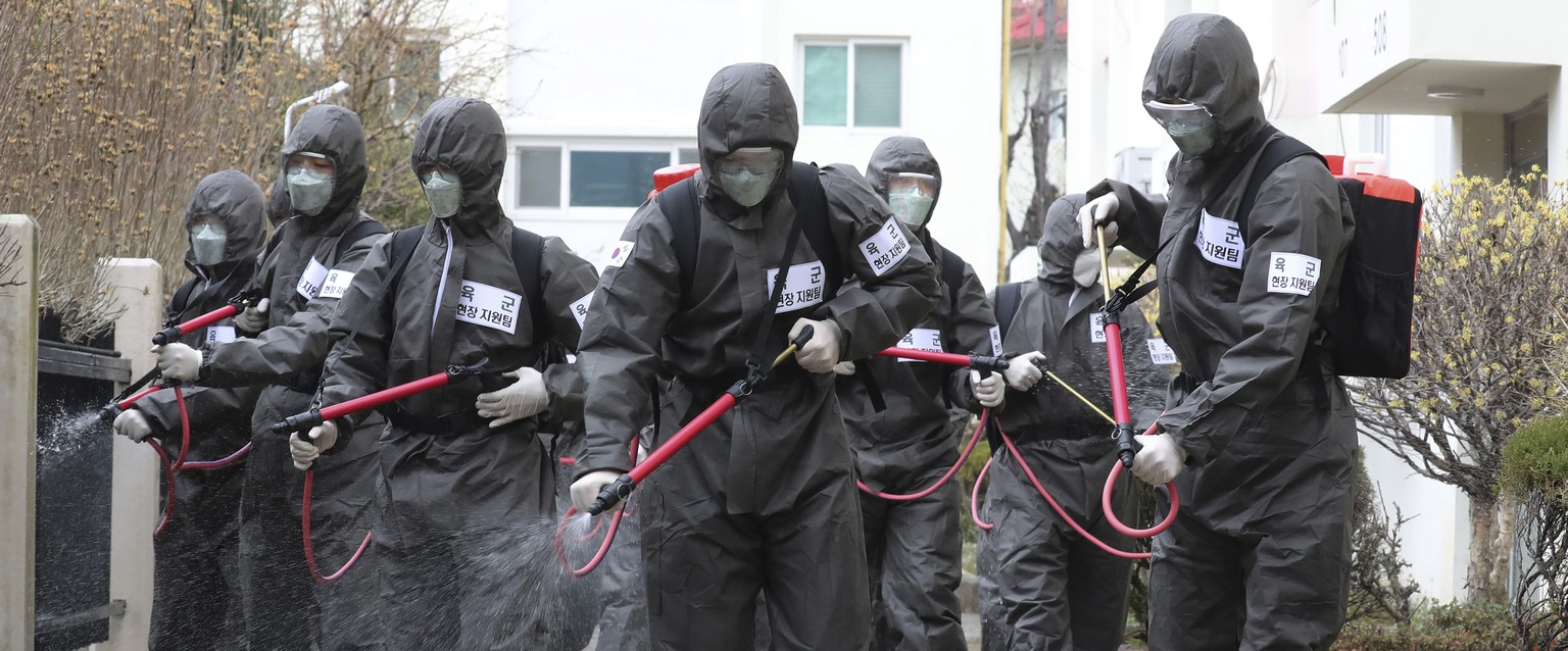 Army soldiers spray disinfectant as a precaution against a new coronavirus at an apartment building in Daegu, South Korea, Monday, March 9, 2020. The worldÄôs largest economies delivered more worriso ...