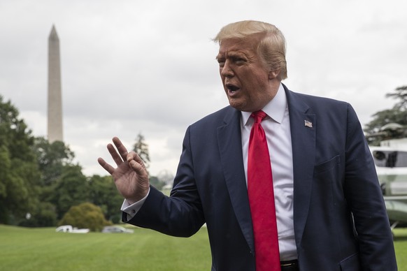 President Donald Trump speaks with reporters as he walks to Marine One on the South Lawn of the White House, Friday, July 31, 2020, in Washington. Trump is en route to Florida. (AP Photo/Alex Brandon) ...