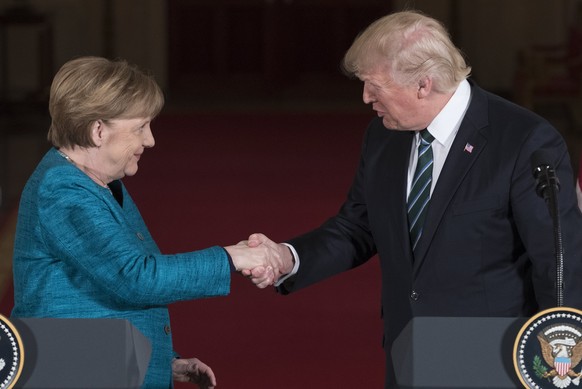 epa05854854 US President Donald J. Trump (R) shakes hands with Chancellor of Germany Angela Merkel (L) during a joint press conference in the East Room of the White House in Washington, DC, USA, 17 Ma ...