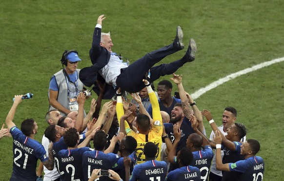 French players throw France head coach Didier Deschamps into the air celebrating at the end of the final match between France and Croatia at the 2018 soccer World Cup in the Luzhniki Stadium in Moscow ...
