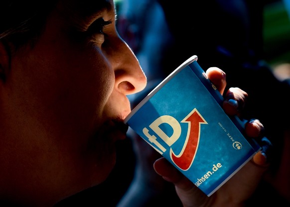 epa07627887 Co-chair of the German right-wing Alternative for Germany (AfD) party Alice Weidel drinks during the AFD election campaign event in Goerlitz, Germany, 05 June 2019. The far-right populists ...