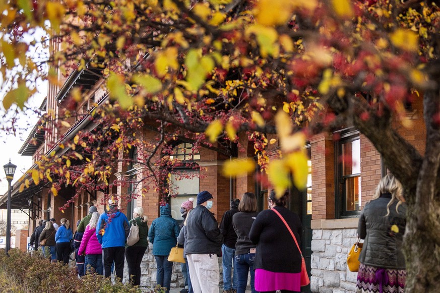 Voters stand in line outside of Pere Marquette Depot to cast their ballots in Bay City, Mich., during Election Day on Tuesday, Nov. 3, 2020. (Kaytie Boomer/The Bay City Times via AP)