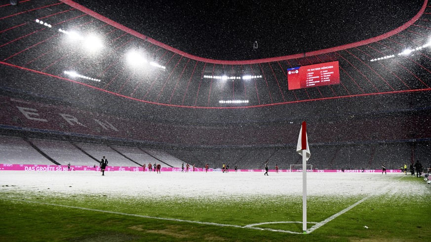 View with snowfall of the stadium during a German Bundesliga soccer match between Bayern Munich and Arminia Bielefeld at the Allianz Arena in Munich, Germany, Monday, Feb. 15, 2021. (AP Photo/Andreas  ...