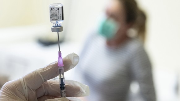 A nurse prepares a dose of Pfizer-BioNTech vaccine against the new coronavirus to be injected at the Andras Josa Teaching Hospital in Nyiregyhaza, Hungary, Sunday, Jan. 24, 2021. (Attila Balazs/MTI vi ...