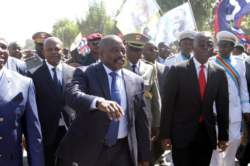 Democratic Republic of the Congo&#039;s President Joseph Kabila (C) greets supporters as he arrives at the airport in Lubumbashi, the capital of Katanga province in the Democratic Republic of Congo, J ...