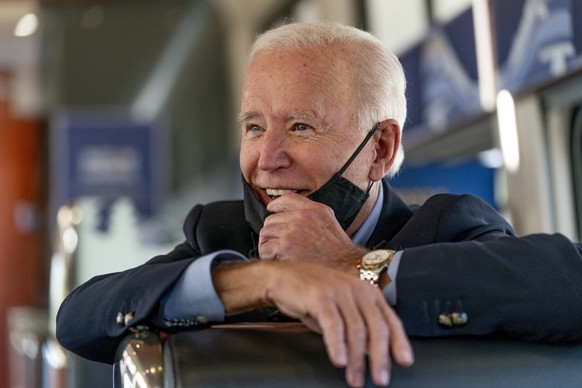 Democratic presidential candidate former Vice President Joe Biden speaks with United Steelworkers Union President Thomas Conway and school teacher Denny Flora of New Castle, Pa., aboard his train as i ...