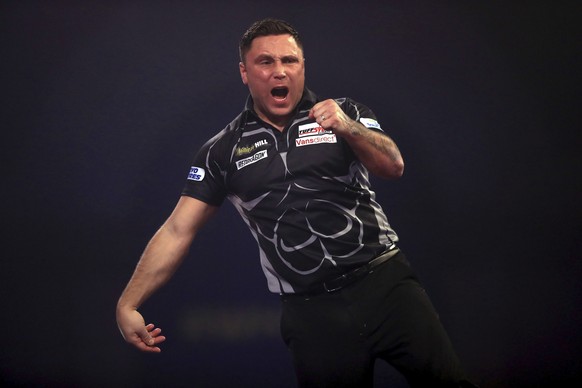Gerwyn Price celebrates during the final against Gary Anderson on day sixteen of the William Hill World Darts Championship at Alexandra Palace, London on Sunday, Jan. 3, 2021. (Adam Davy/PA via AP)