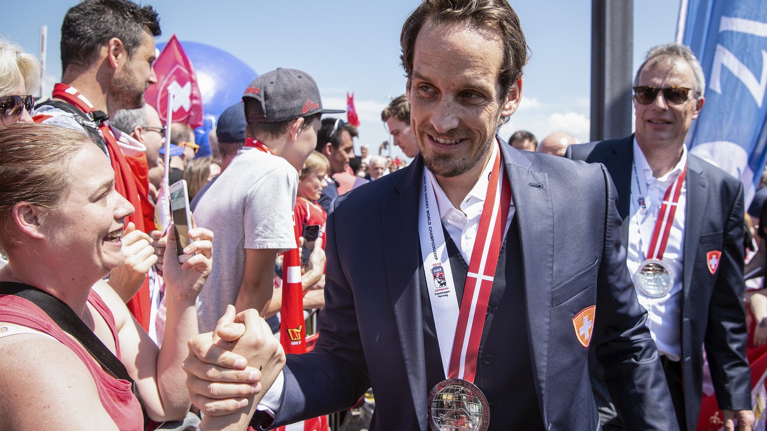 Switzerland’s ice hockey team with coach Patrick Fischer arrives and is welcomed by fans at Zurich airport in Kloten, Switzerland, Monday, May 21, 2018. Switzerland won the silver medal at the IIHF Wo ...