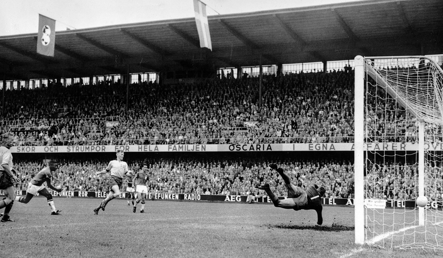 Seventeen-year-old Pele, second from left, scores Brazil&#039;s third goal in the World Cup soccer final against Sweden in Stockholm, June 29, 1958. At right, Sweden&#039;s goalkeeper Kalle Svensson m ...