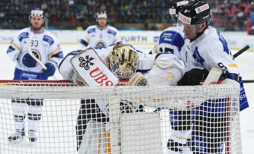 Luganos goalkeeper Elvis Merzlikins and Tony Martensson react after the canada goal to 4-1 during the final game between Team Canada and Switzerlands HC Lugano at the 90th Spengler Cup ice hockey tour ...