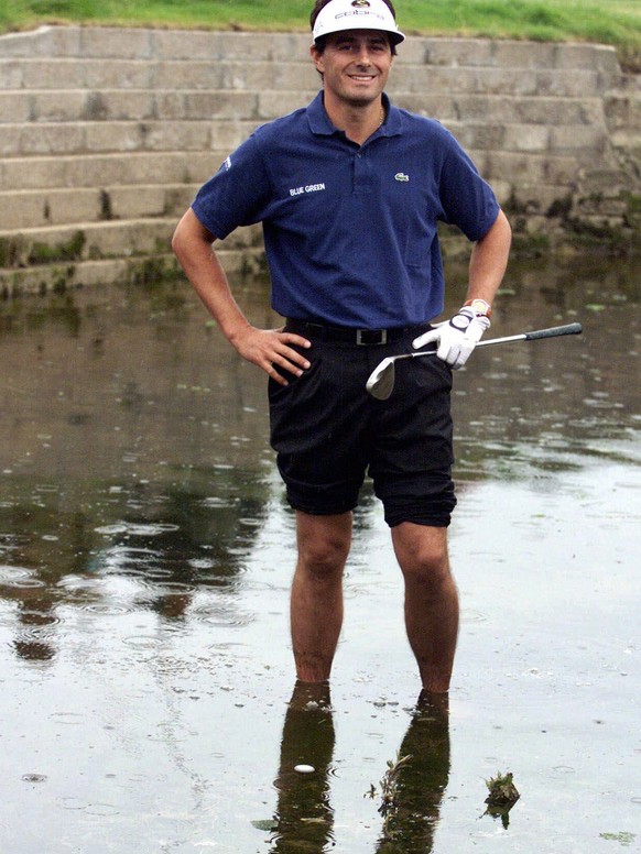 FILE - In this July 18, 1999, file photo, France&#039;s Jean Van de Velde smiles as he stands in the water of the Barry Burn that crosses the 18th fairway to see if his ball, bottom center, was playab ...