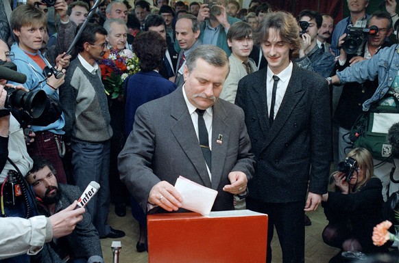 FILE - In this Sunday, June 4, 1989 file photo, Lech Walesa, leader of the Solidarity Union, casts his vote alongside his eldest son Bogdan, in Gdansk, Poland. In June 1989 Solidarity won a landslide  ...
