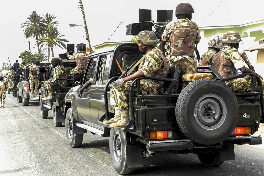 epa04678488 A photograph made available on 25 March 2015 shows the Nigerian military on patrol after flushing out Boko Haram Islamic militants from Michika, North East Nigeria, 19 March 2015. The Nige ...