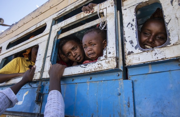Tigray refugees who fled the conflict in the Ethiopia&#039;s Tigray ride a bus going to the Village 8 temporary shelter, near the Sudan-Ethiopia border, in Hamdayet, eastern Sudan, Tuesday, Dec. 1, 20 ...