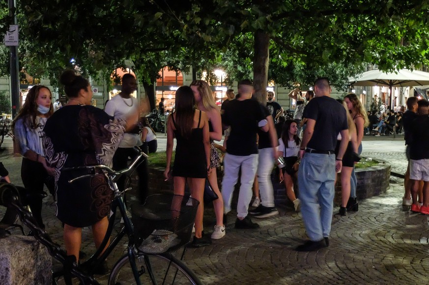 epa08541593 A view of the Milanese nightlife along the Corso Sempione and Arco della Pace, in Milan, northern Italy, early 12 July 2020. Nightlife has returned to Milan amid restrictions due to the co ...