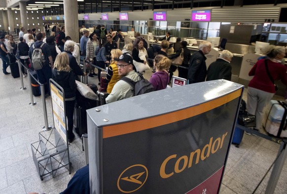 People queue at a counter of Condor airline, owned by Thomas Cook, at the airport in Frankfurt, Germany, Monday, Sept. 23, 2019. Germany&#039;s Condor airline says it can no longer carry travelers who ...