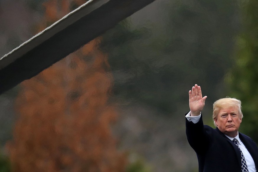 epa06434438 US President Donald J. Trump waves to journalists as he boards Marine One on departure from Walter Reed National Military Medical Center following his annual physical examination in Bethes ...