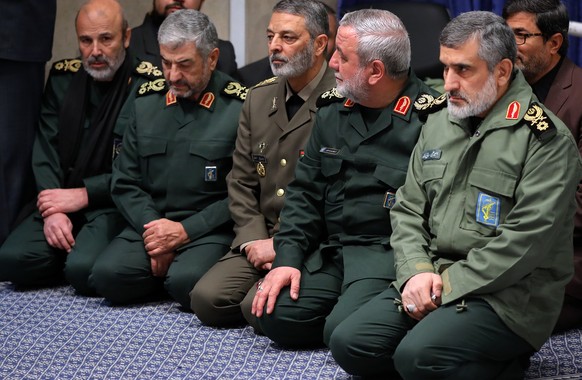 In this Thursday, Jan. 9, 2020 photo released by an official website of the office of the Iranian supreme leader, Gen. Amir Ali Hajizadeh, the head of the Guard&#039;s aerospace division, right, atten ...