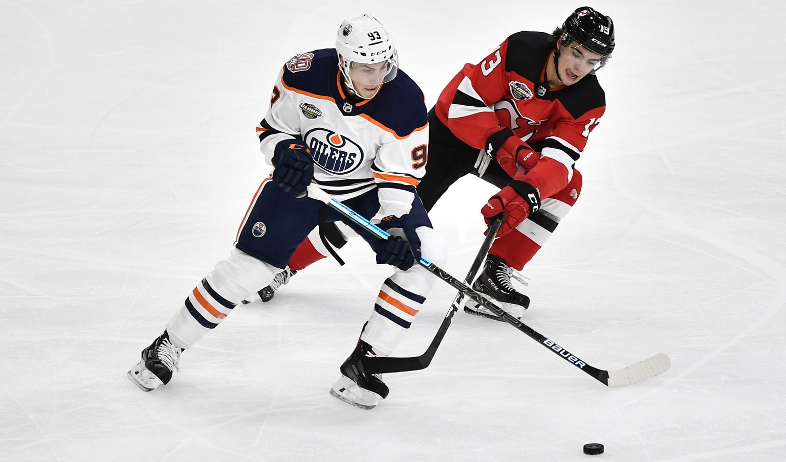 epa07074636 Edmonton Oilers Ryan Nugent-Hopkins (L) and New Jersey Devils Nico Hischier in action during the season-opening NHL Global Series icehockey match between Edmonton Oilers and New Jersey Dev ...