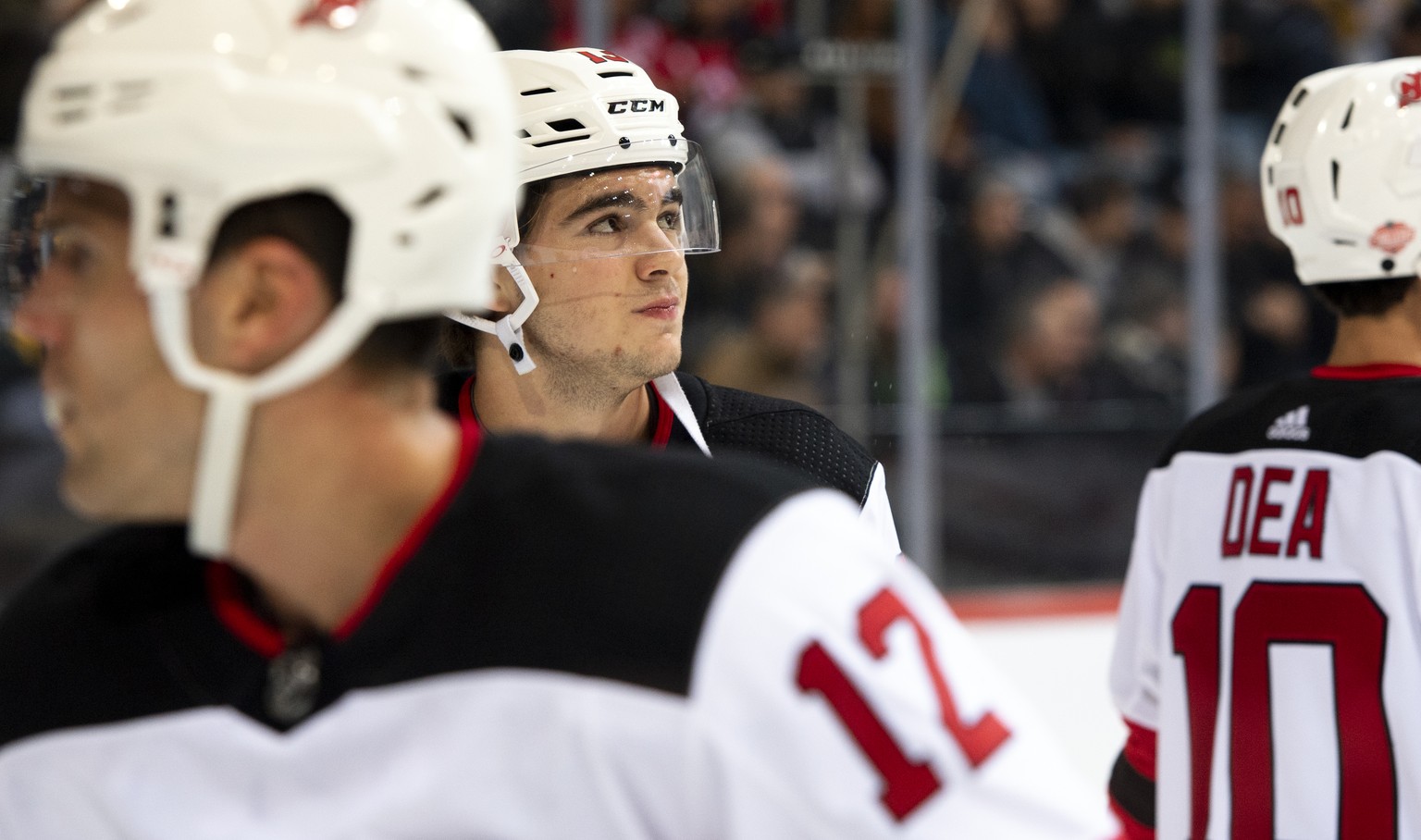 New Jersey Devils Nico Hischier, center, pictured next to New Jersey Devils Ben Lovejoy , left, and New Jersey Devils Jean-Sebastien Dea, right, during the warm up prior a NHL friendly game between Sw ...