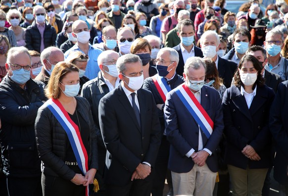 The sub prefect Herve Jonathan, second left, surrounded by local elected officials, observe a minute of silence in Bayonne, southwestern France, Sunday, Oct. 18, 2020, in memory of the teacher Samuel  ...
