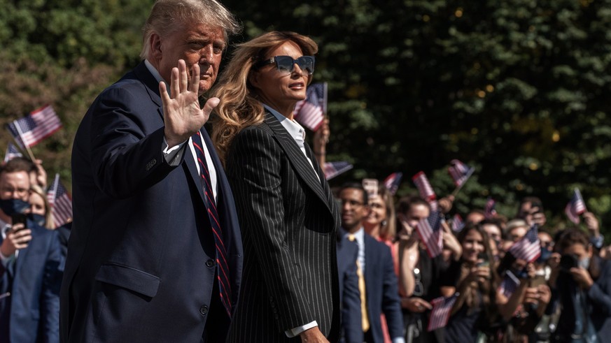 epa08714424 (FILE) - US President Donald J. Trump (L) and First Lady Melania Trump (R) wave to supporters as they walk across the South Lawn to Marine One at the White House in Washington, DC, USA, 29 ...
