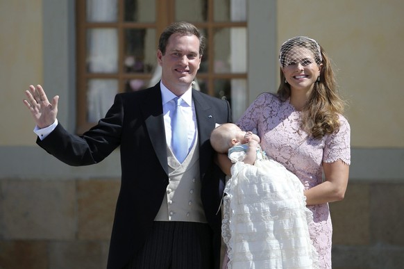 epa04244902 (L-R) Mr Christopher O&#039;Neill, Princess Leonore and Princess Madeleine of Sweden wave to the crowd outside the church after the christening ceremony in the Drottningholm Palace church  ...