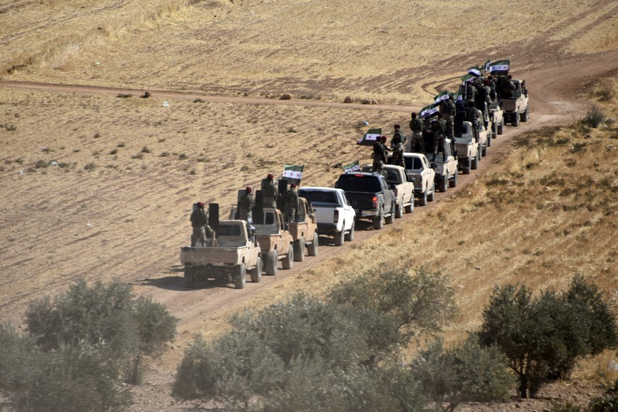 Turkey-backed FSA fighters are heading toward Syrian town of Tal Abyad from Turkish border town of Akcakale, Turkey, Thursday, Oct. 10, 2019. Turkish President Recep Tayyip Erdogan says that there hav ...